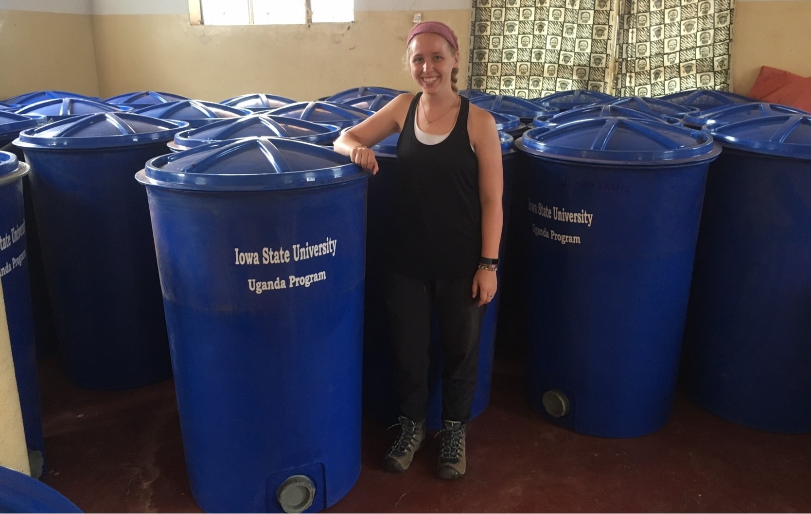 Hermetic silos in Uganda with ISU student in foreground